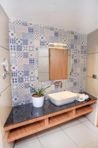 a bathroom with a sink and a mirror at Hotel Sky Sierra Wayanad in Kalpetta