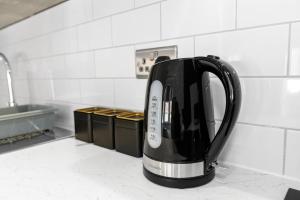 a black tea kettle sitting on a kitchen counter at Sleek and Stylish Converted 1Bed in Old Boiler Factory - Flat 4 in Nottingham