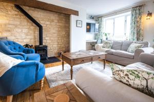 a living room with a couch and a fireplace at Mill Village 67, Driftwood Lake House - P in Somerford Keynes