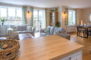 a living room with a couch and a table at Mill Village 67, Driftwood Lake House - P in Somerford Keynes