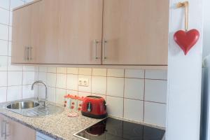 a kitchen with a sink and a red toaster on the counter at Casa MiraMar - Las Torres del Castillo in Costa de Antigua