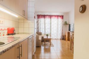 a kitchen and a living room with a table at Casa MiraMar - Las Torres del Castillo in Costa de Antigua