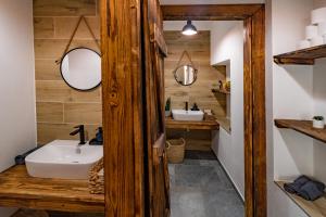 a bathroom with a sink and a mirror at Hotel Smrž in Sepekov +81 photos
