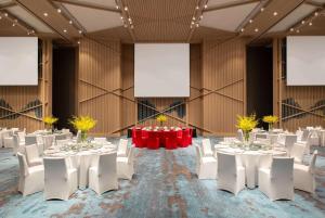 a banquet hall with white tables and white chairs at Wyndham Sun Moon Lake in Yuchi