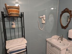 a bathroom with a sink and a mirror at Vík Hostel in Vík