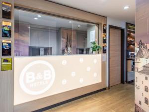 a hotel entrance with a sign on a glass door at B&B Hotel Regensburg-City in Regensburg