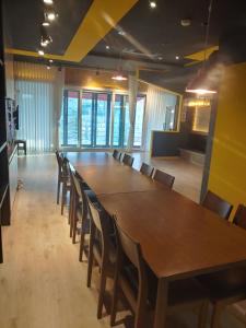 a large conference room with a long table and chairs at T stay pension in Cheongju