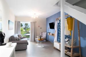 a living room with blue walls and a couch at Argile Resort & Spa in Lixouri