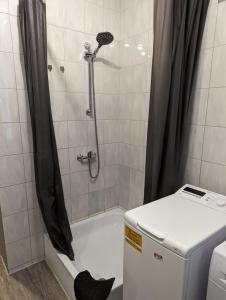a shower with a black shower curtain next to a toilet at Flensburg Zentrum 50 in Flensburg