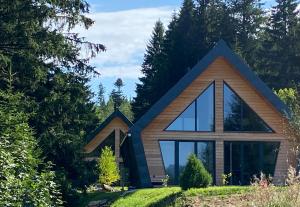 a house with a large window on a hill at Chalet Belveder RELAX in Železná Ruda