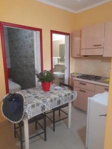 a kitchen with a table with a potted plant on it at Villaggio Mare Blu in Vieste