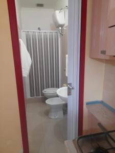a small bathroom with a toilet and a sink at Villaggio Mare Blu in Vieste