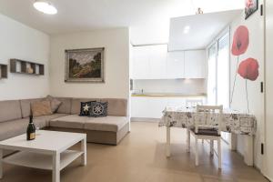 a living room with a couch and a table at Comfort Central City Suite in Rimini