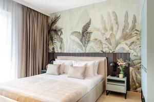 a bedroom with a large bed with a floral wallpaper at Reset in Muse Spa Collection in Krakow +276 photos