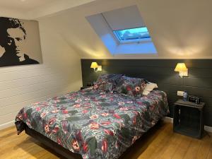 a bedroom with a bed and a skylight at Le repos du Wayai in Theux