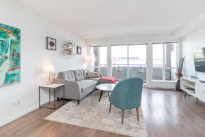 a living room with a couch and a table at Chinatown Chic Suite by Iris Properties! in Victoria