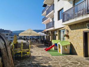 a patio with a play set and a playground at Family Hotel Bela in Tryavna