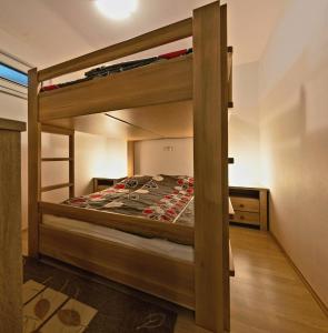 a bedroom with two bunk beds in a room at Apartma Krvavec - cosy mountain retreat in Cerklje na Gorenjskem