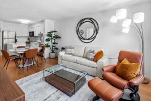a living room with a couch and a table at Astoria Elegance by Iris Properties in Victoria
