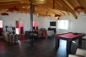 a living room with a ping pong table in it at Monte da Ameixa Country House in Castro Verde