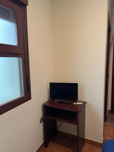 a room with a desk with a television on it at HOSTAL TREVELEZ in El Ejido