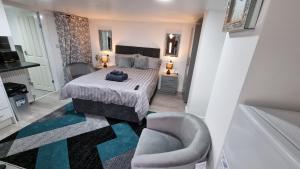 a bedroom with a bed and a chair in it at Comfy Studio apartment with Wi-Fi and Smart TV in Leeds