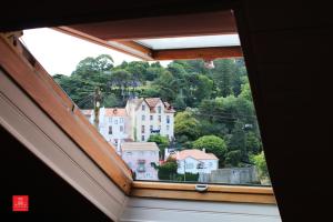 a view of a city from a window in a house at Casas da Biquinha in Sintra
