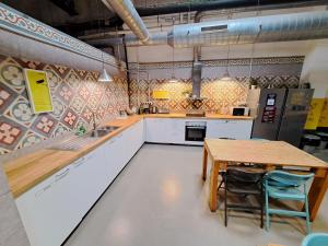 a large kitchen with a wooden table and chairs at Bed and Bike Barcelona in Barcelona