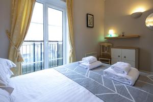 a bedroom with a large bed with towels on it at Mill Village 81, Trout Cottage in Somerford Keynes +20 photos