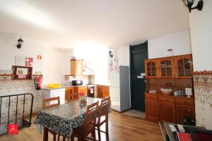 a kitchen with a table and chairs in a room at Casas da Biquinha in Sintra