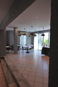 a large room with a table and chairs at Anamar Skiathos Hotel in Punta