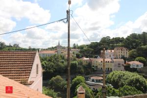 a view of a city from the roof of a building at Casas da Biquinha in Sintra