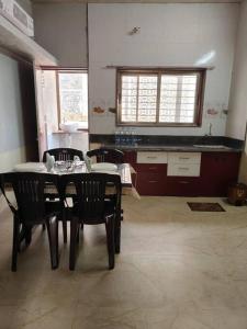 a kitchen with a table and chairs in a room at Suite with valley view Panhala Fort in Panhāla