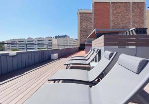 a row of benches on the roof of a building at Stay U-nique Apartments Pellaires in Barcelona