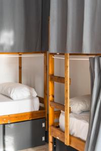 two bunk beds in a dorm room at Ocean Nomads Coworking in Arona
