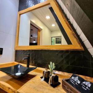 a bathroom with a sink and a mirror at Reserva Guimarães in Cambará