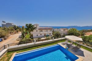 a view of a swimming pool and a house at Luxury Sea View Villa w Pool By The Sea in Antalya in Demre