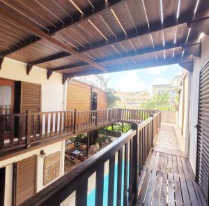 a balcony of a house with a wooden deck at Sannyasa Wellness and Spa in Trou aux Biches