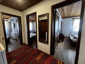 a room with a hallway with a mirror and a bathroom at Кондеви къщи in Kovachevitsa