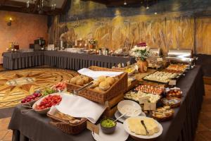 a buffet line with different types of food on display at Hotel Żubrówka Spa & Wellness in Białowieża
