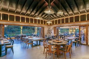 a restaurant with tables and chairs and large windows at Titanic Deluxe Golf Belek in Belek
