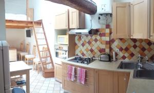 a kitchen with a sink and a stove top oven at Location saisonnière dans le cœur historique – T3 pour 4 à 6 personnes in La Ciotat