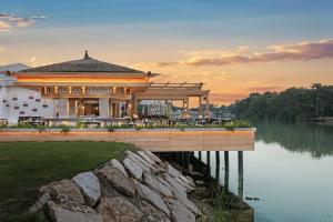 a building on a dock next to a body of water at Titanic Deluxe Golf Belek in Belek
