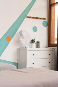 a bedroom with a bed and a white dresser at Ocean Nomads Coworking in Arona