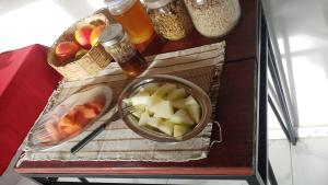 a table with a bowl of food and a bowl of fruit at Pousada Ostara in Alto Paraíso de Goiás