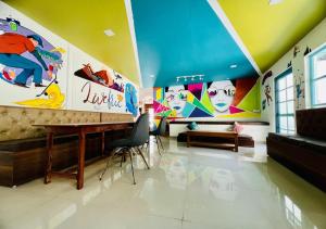 a room with colorful walls and a table and chairs at Hotel Starwud Kotagge Dharamshala in Dharmsala