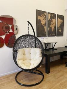 a swing chair in a room with a table at CASA IVH BNB in Florence