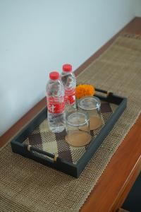 a tray with water bottles and flowers on a table at Santera Village in Canggu