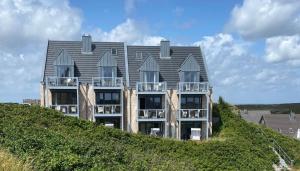 a large building on top of a hill at Beachhouse Beachhouse 5 in Hörnum