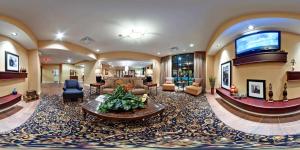 a large lobby with a living room with a couch at Hampton Inn Jackson-College Avenue in Jackson